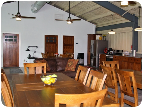 A dining room with wooden chairs and tables.