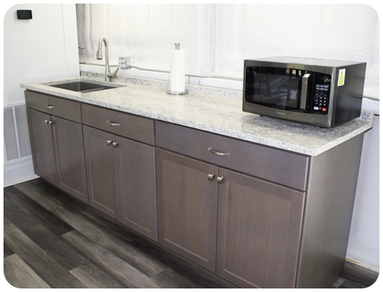 A microwave oven sitting on top of a counter.