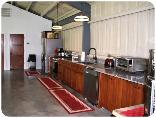 A kitchen with a stove, microwave and refrigerator.