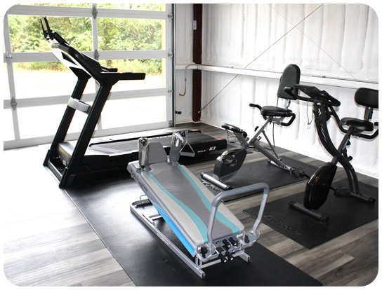 A gym with many different types of exercise equipment.