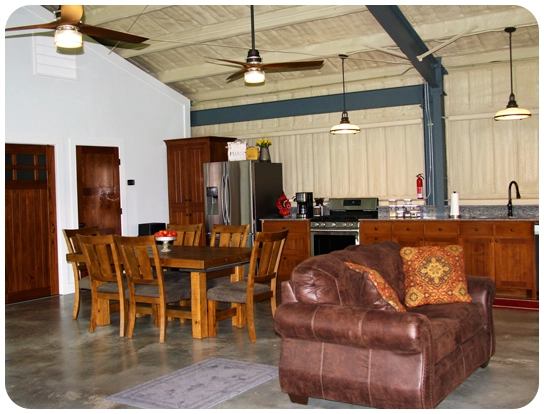 A living room with a couch, table and chairs.