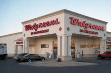 A walgreens store with cars parked outside of it.