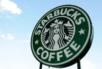 A starbucks sign with the logo of a woman.