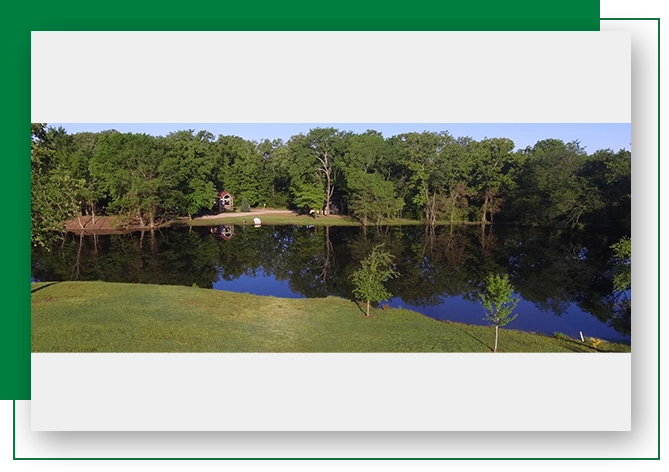 A large body of water surrounded by trees.