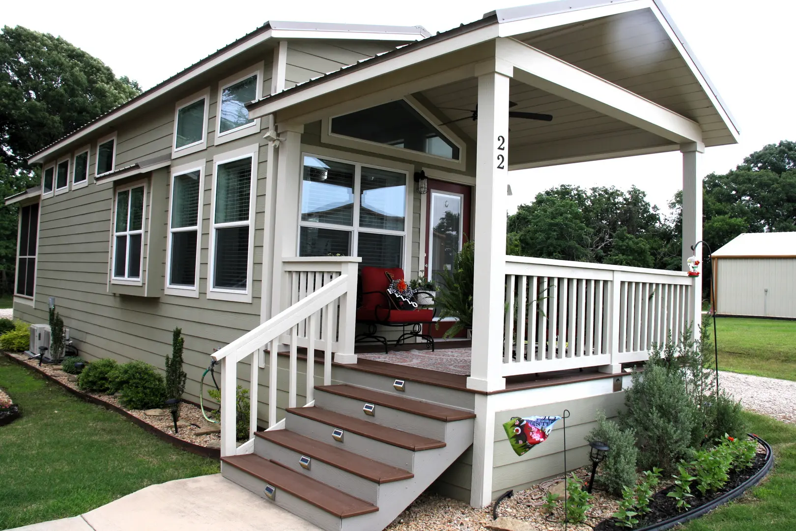 A porch with steps leading to the front door.