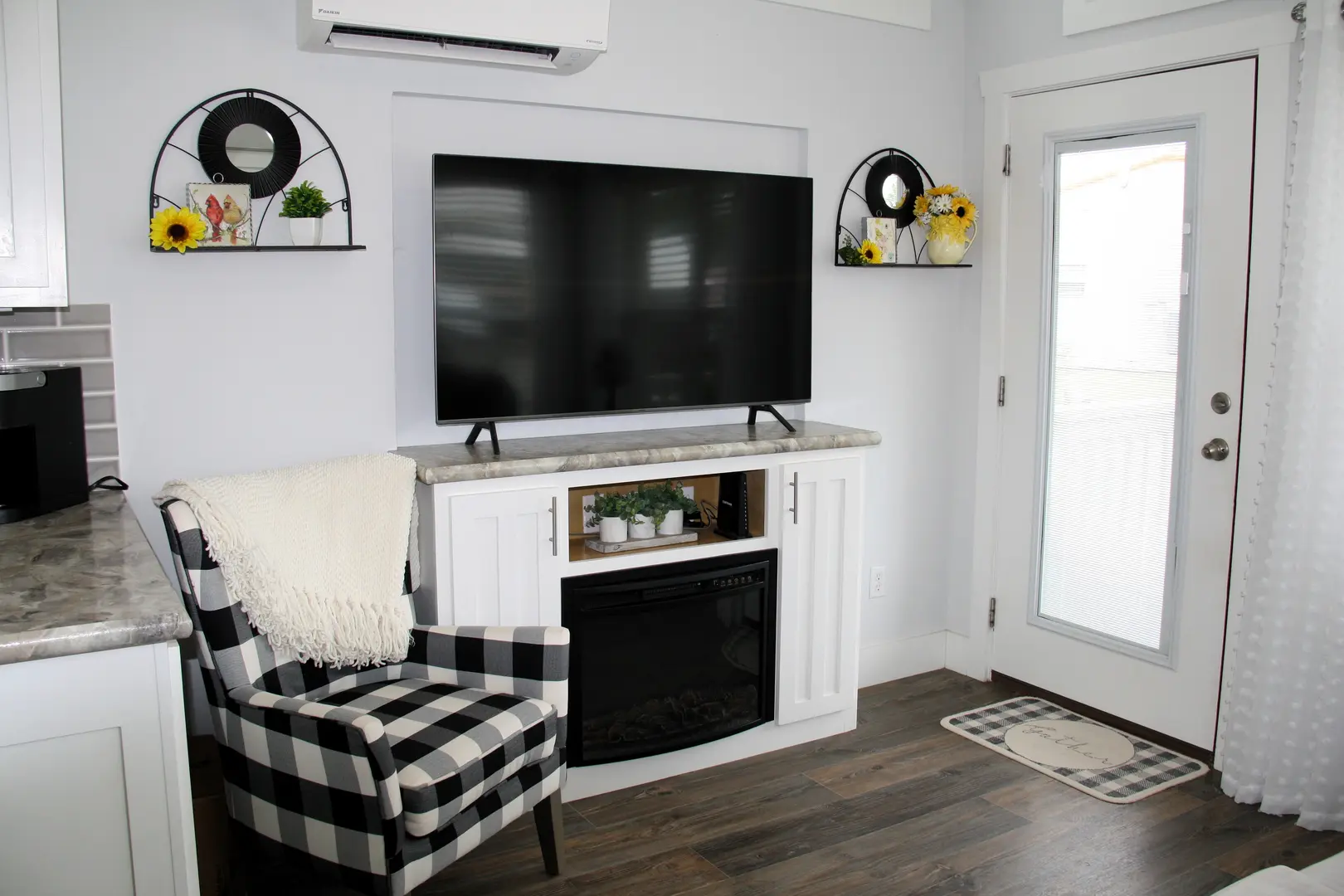 A living room with a fireplace and tv