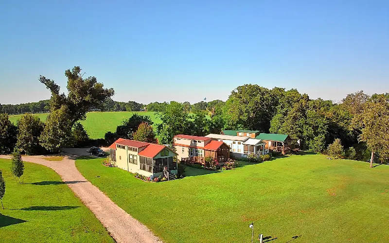 A group of houses in the middle of a field.