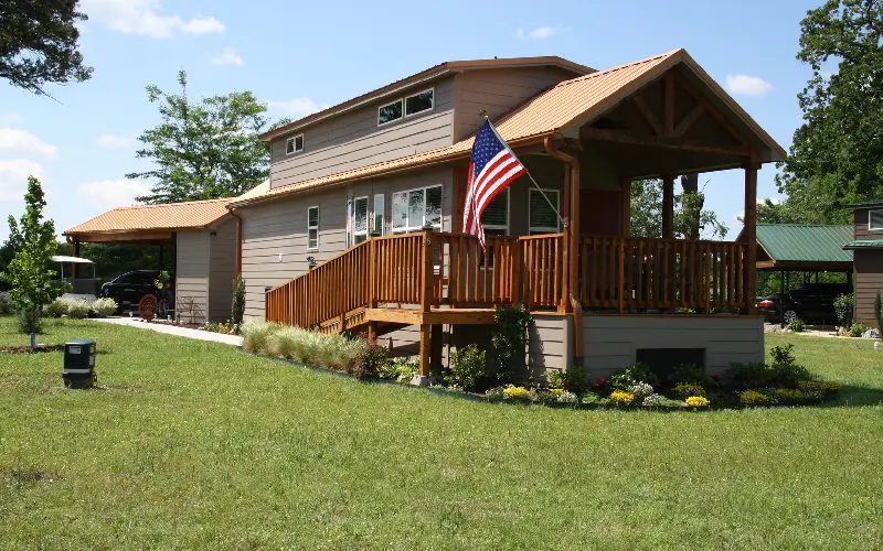 A house with an american flag on the front porch.