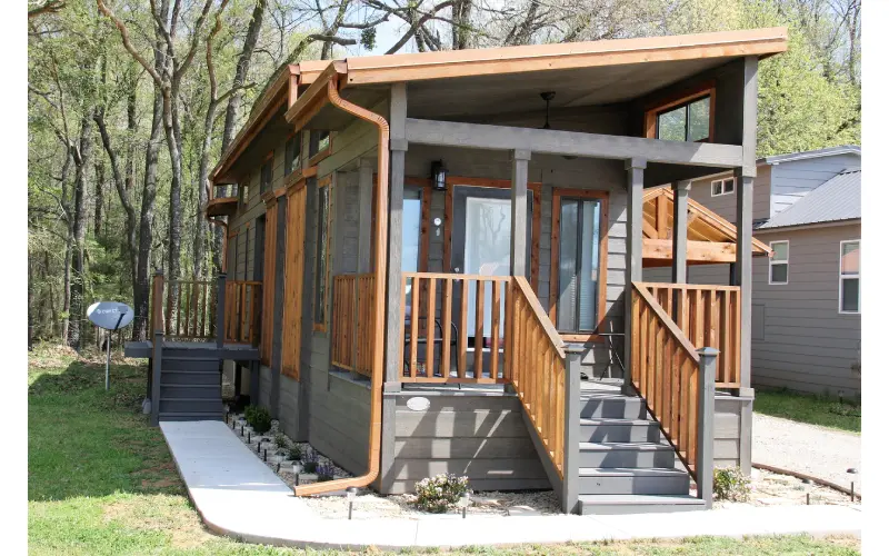 A porch with steps leading to the front of a house.