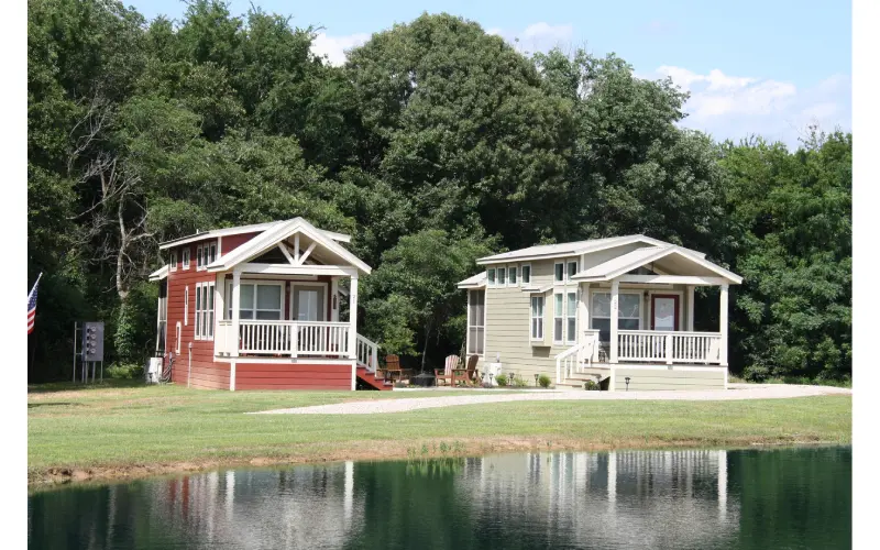 Two houses sitting next to each other near a body of water.