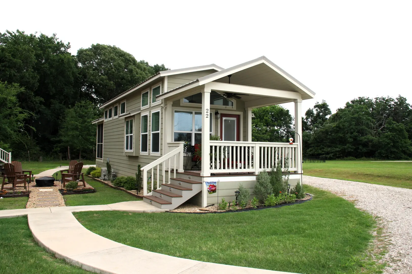 A small house with a porch and steps leading to the front.