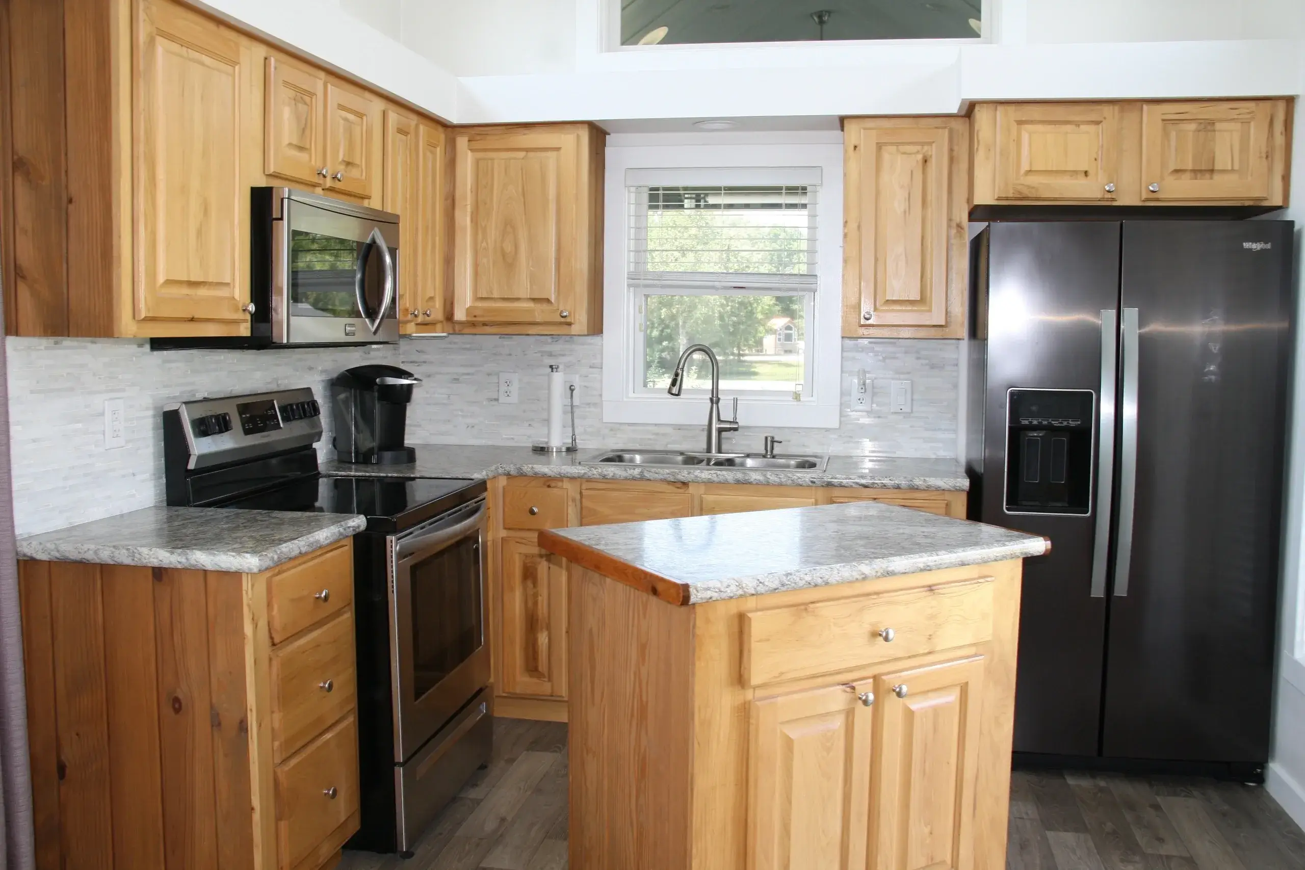 Modern kitchen with wooden cabinets and appliances.