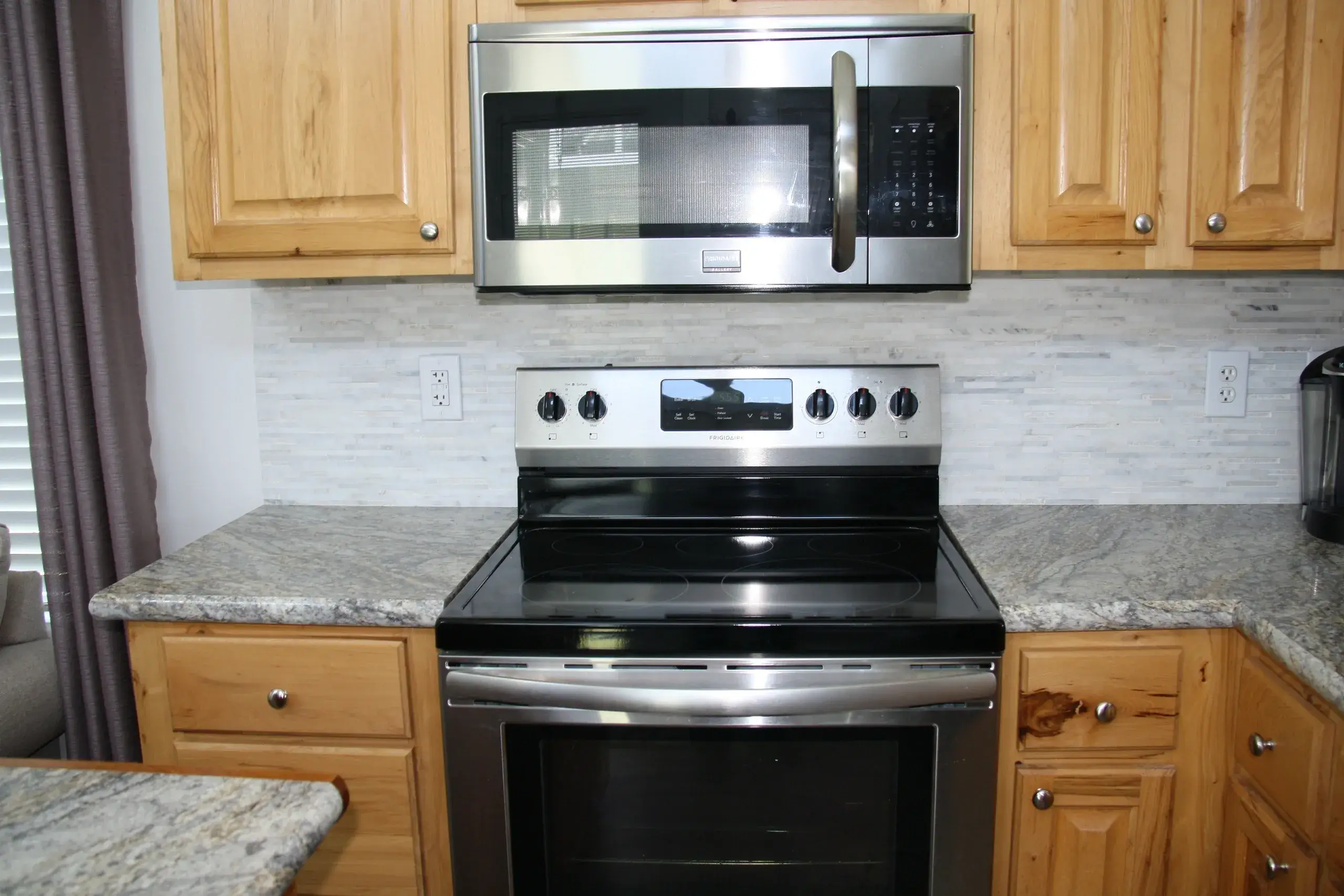 Modern kitchen with stainless steel appliances.