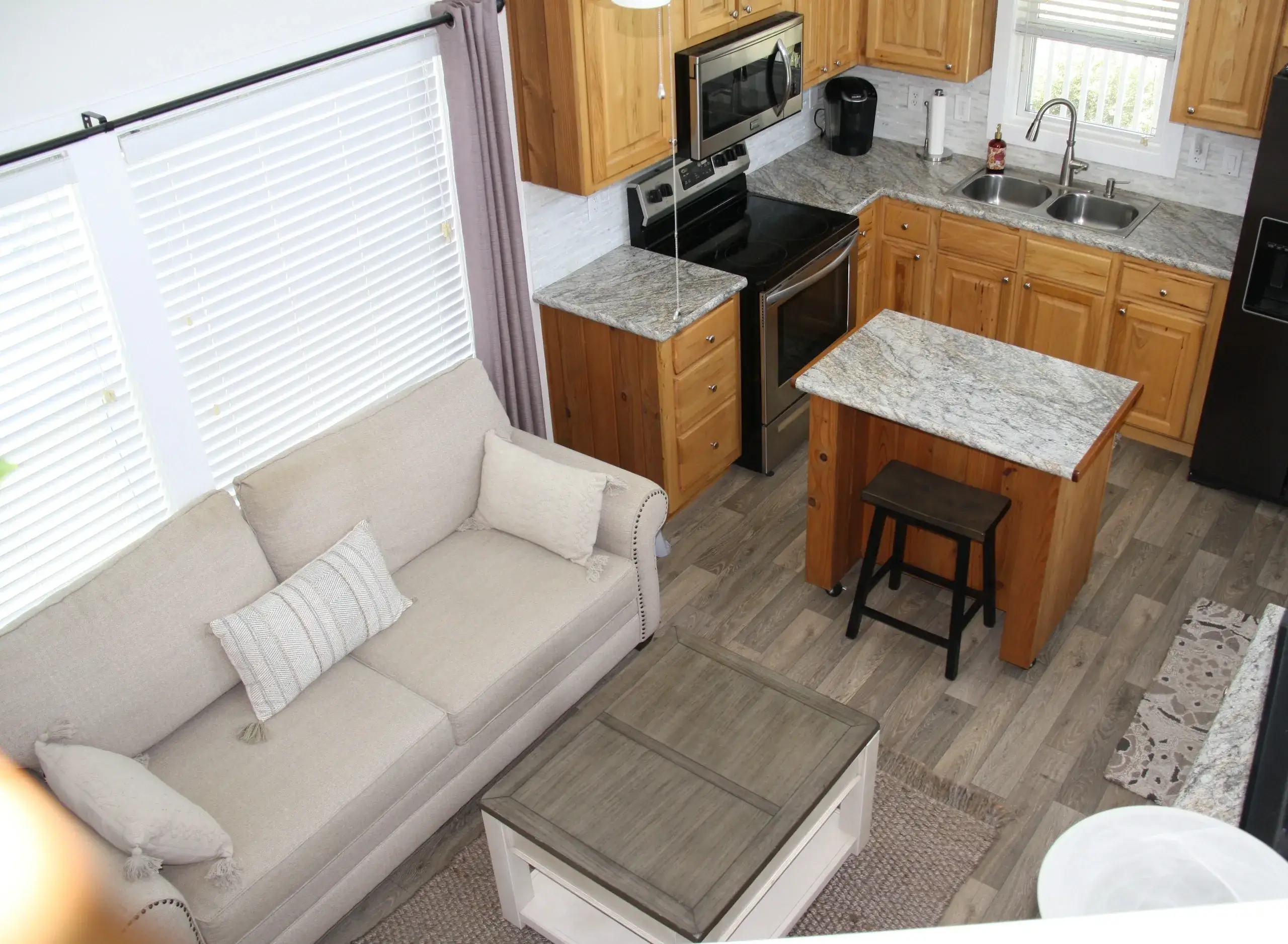 Modern kitchen and living area with island.