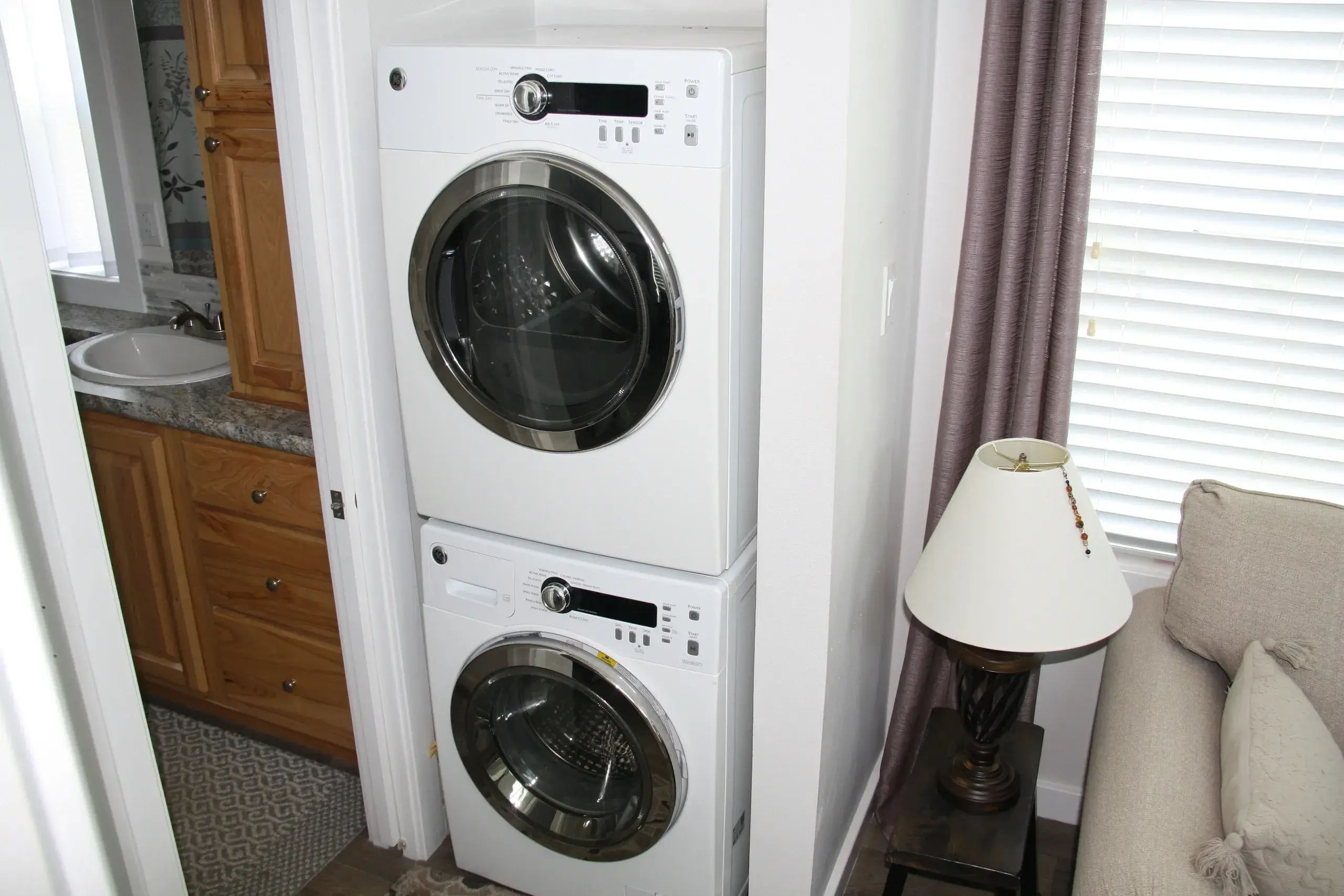 Stacked washer and dryer in corner space.