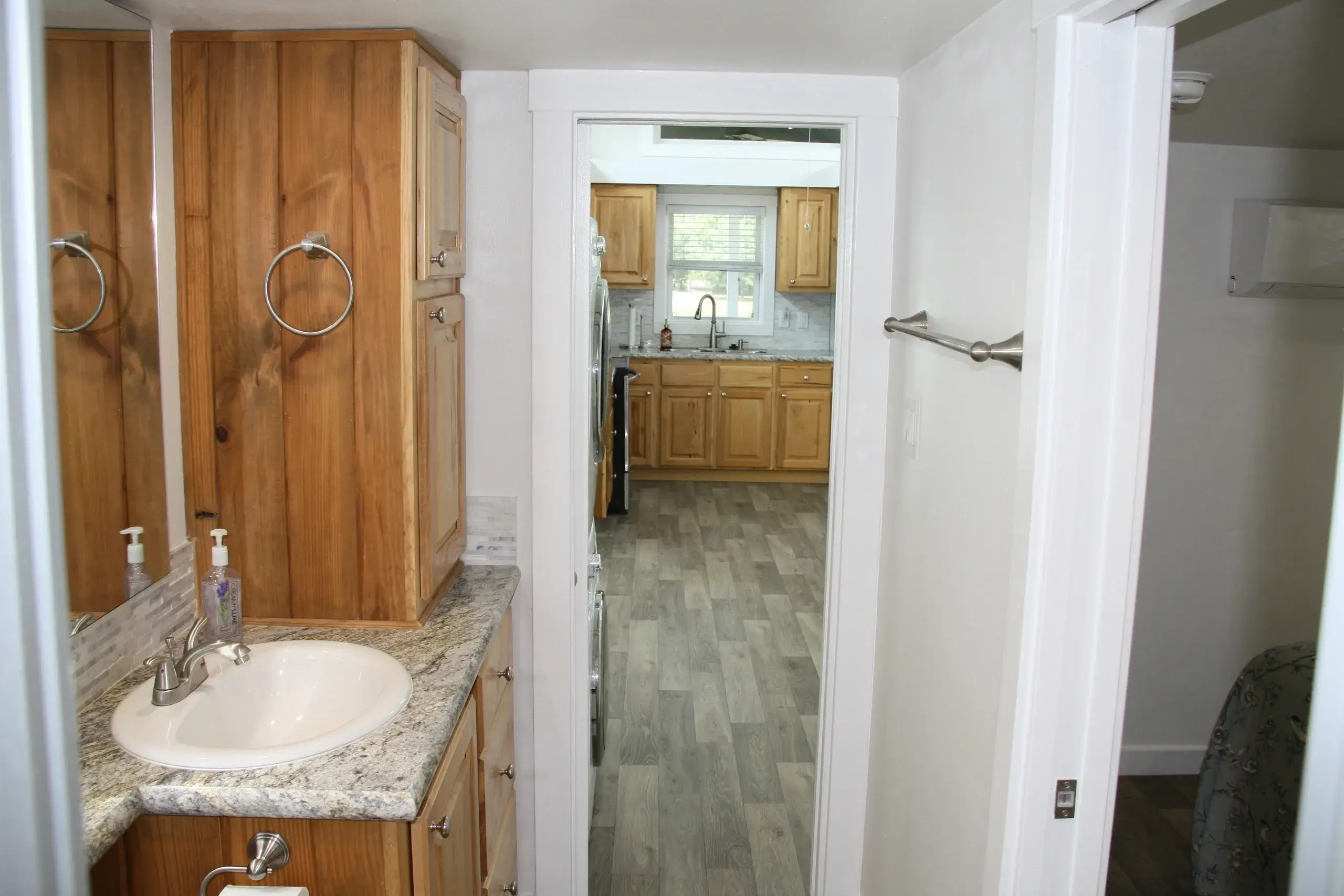 Bathroom view leading into kitchen area.