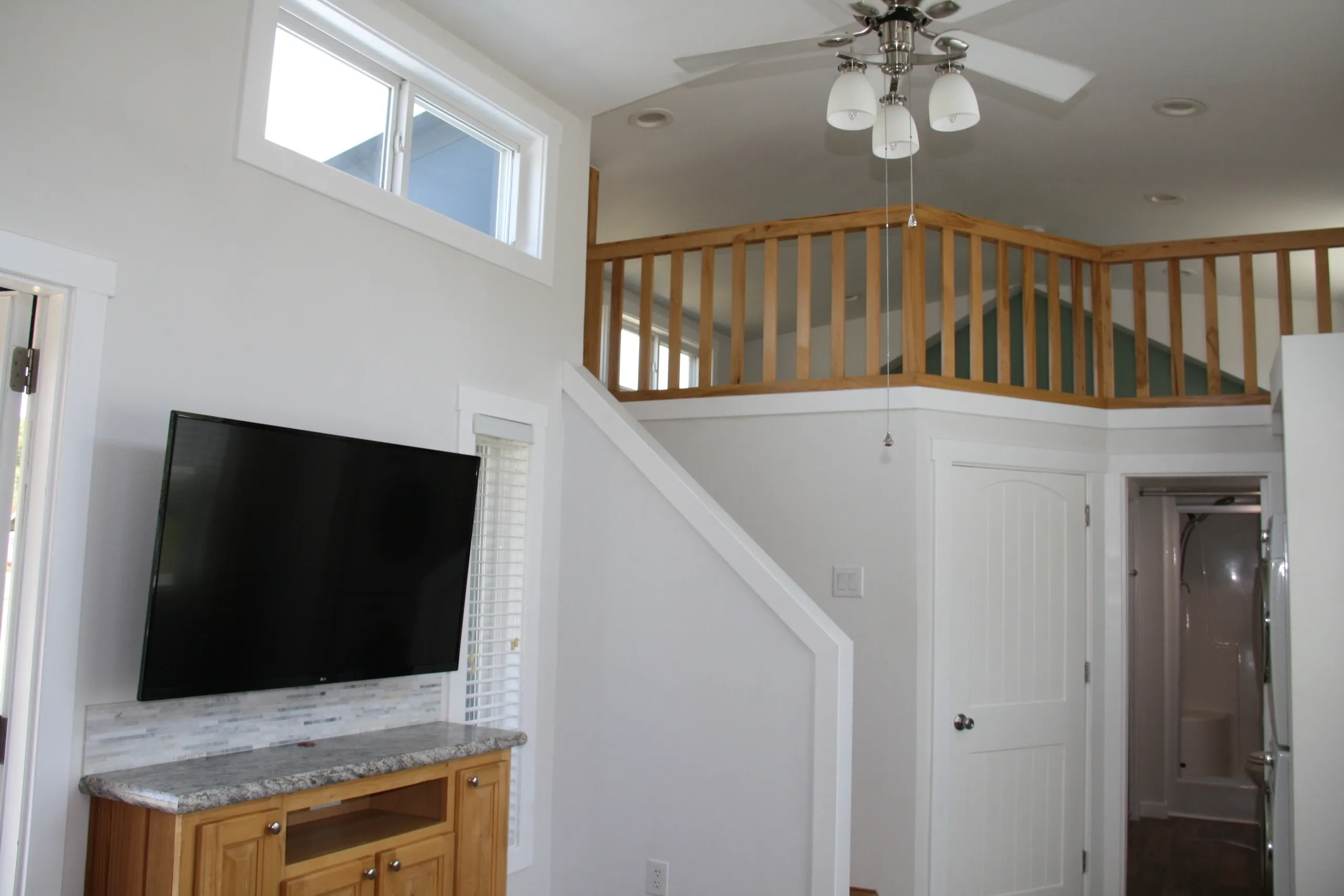 Modern living room with loft and TV.